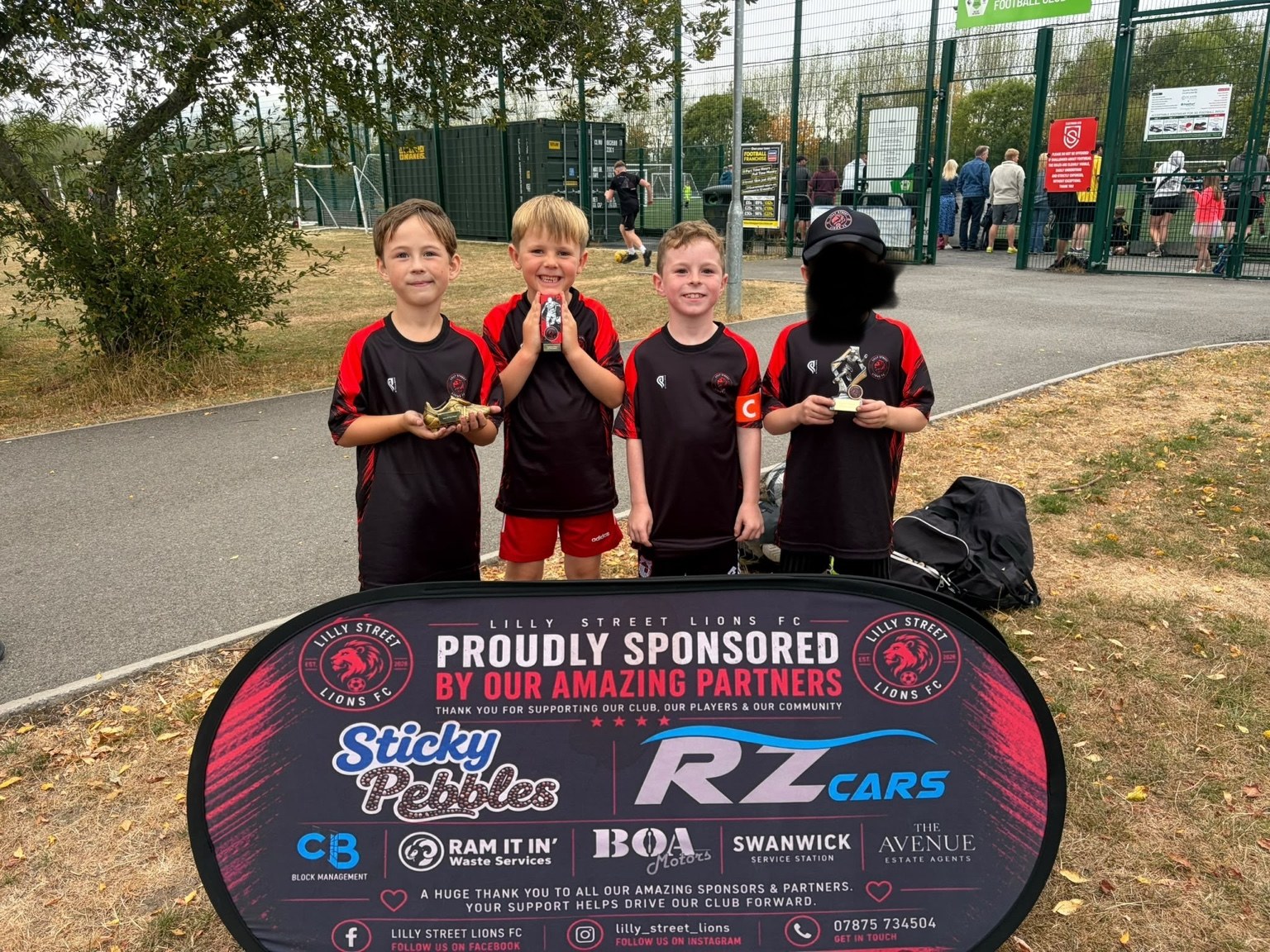 Under-8 players holding team awards
