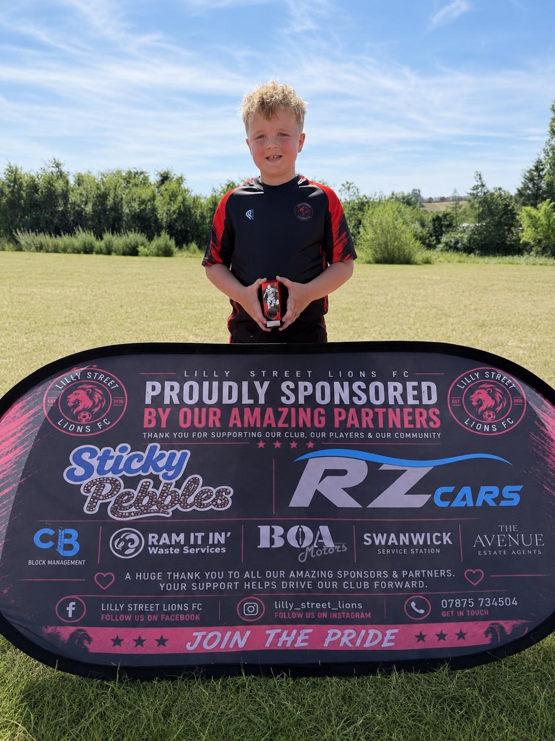 Under-8 player holding a weekly award